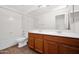 Clean bathroom featuring double sinks with oak cabinets and shower-tub combo at 1079 S Western Skies Dr, Gilbert, AZ 85296