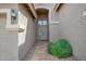 Arched front entryway featuring covered porch and desert landscaping at 1079 S Western Skies Dr, Gilbert, AZ 85296