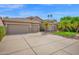 Inviting home featuring a tile roof, 3 car garage, and well maintained desert landscaping at 1079 S Western Skies Dr, Gilbert, AZ 85296