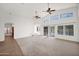 Open living room with high ceilings, neutral paint, carpet, and large windows at 1079 S Western Skies Dr, Gilbert, AZ 85296