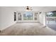 Bright living room featuring carpet, large windows, and a view of the backyard at 1079 S Western Skies Dr, Gilbert, AZ 85296