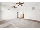 Spacious living room featuring carpet floors, neutral paint, and ceiling fans at 1079 S Western Skies Dr, Gilbert, AZ 85296