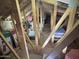Unfinished attic space featuring wooden beams and ample storage capacity at 10909 E Sentiero Ave, Mesa, AZ 85212