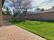 Backyard with grassy area, trampoline, and monkey bars at 10909 E Sentiero Ave, Mesa, AZ 85212