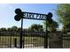 Community Bark Park with rules posted on a sign that is bone shaped at the top, surrounded by a fence at 10909 E Sentiero Ave, Mesa, AZ 85212