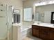 Bright bathroom features a double vanity, bathtub, and glass-enclosed shower, all well lit with modern fixtures at 10909 E Sentiero Ave, Mesa, AZ 85212