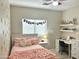 Bedroom features a pink bed and a desk next to the bed at 10909 E Sentiero Ave, Mesa, AZ 85212
