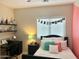 Cozy bedroom with dark furniture and lots of pillows at 10909 E Sentiero Ave, Mesa, AZ 85212