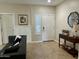 Inviting entryway featuring a console table, neutral paint, tiled floors, and well-placed decorations at 10909 E Sentiero Ave, Mesa, AZ 85212