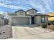 Charming single-story home with a neutral stucco finish, well-kept landscaping, and a spacious two-car garage at 10909 E Sentiero Ave, Mesa, AZ 85212