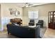 Comfortable living room features tile floors, decorative wainscoting and a large window for plenty of natural light at 10909 E Sentiero Ave, Mesa, AZ 85212