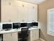Functional home office space features built-in cabinets and desk space, perfect for remote work or studying at 10909 E Sentiero Ave, Mesa, AZ 85212