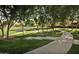 Scenic park view with curved walking paths and plenty of trees for shade and tranquility at 10909 E Sentiero Ave, Mesa, AZ 85212