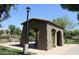 A stone picnic pavilion at the community park with shaded seating for residents to enjoy at 10909 E Sentiero Ave, Mesa, AZ 85212