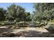 Picturesque walking path lined with mature trees and benches to rest and enjoy the serene surroundings at 10909 E Sentiero Ave, Mesa, AZ 85212