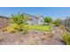 Backyard putting green with lush desert landscaping and artificial turf at 12035 W Roy Rogers Rd, Peoria, AZ 85383