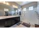 Modern bathroom featuring dual sinks, a sleek vanity, and a spacious glass-enclosed shower for a luxurious experience at 12035 W Roy Rogers Rd, Peoria, AZ 85383