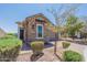 Charming single-story home featuring stone accents, manicured landscaping, and a paved driveway leading to a garage at 12035 W Roy Rogers Rd, Peoria, AZ 85383