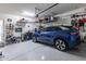 Spacious garage featuring ample storage, tools, and a blue electric car at 12035 W Roy Rogers Rd, Peoria, AZ 85383