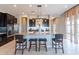 Beautiful kitchen with granite countertops, black cabinets, modern appliances, and a spacious center island with seating at 12035 W Roy Rogers Rd, Peoria, AZ 85383