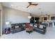 Comfortable living room featuring a large sectional sofa, open layout, and seamless access to the adjacent kitchen at 12035 W Roy Rogers Rd, Peoria, AZ 85383