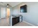Convenient wet bar with modern fixtures, sleek cabinetry, a sink, and a mini-fridge for effortless entertaining at 12035 W Roy Rogers Rd, Peoria, AZ 85383