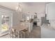 Cozy dining area with a chandelier, white cabinets, stainless steel appliances and outdoor access at 12333 W Corrine Dr, El Mirage, AZ 85335