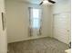 Carpeted bedroom with a ceiling fan and a double door closet adjacent to a window with white patterned curtains at 14127 W Buckskin Trl, Surprise, AZ 85387