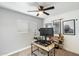 Bedroom featuring a home office with a ceiling fan, natural light, and modern décor at 1504 W 6Th St, Mesa, AZ 85201