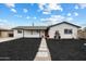 Charming single-story home featuring a red front door, manicured front yard, and sidewalk at 1504 W 6Th St, Mesa, AZ 85201