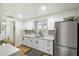 Contemporary kitchen with stainless steel appliances, white cabinets, and a sleek design at 1504 W 6Th St, Mesa, AZ 85201