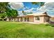 Spacious backyard with mature trees and a covered patio area for relaxing and entertaining at 18442 N 104Th Ave, Sun City, AZ 85373