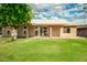 Well maintained green backyard features a covered patio and beautiful mature landscaping at 18442 N 104Th Ave, Sun City, AZ 85373