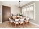 Inviting dining room featuring wood table, seating for six, and natural light through shuttered windows at 18442 N 104Th Ave, Sun City, AZ 85373