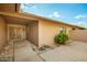 Charming front entrance featuring a secure screen door, well-maintained shrubs, and gravel landscape at 18442 N 104Th Ave, Sun City, AZ 85373