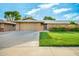Charming single-story home features a manicured lawn and an attached two-car garage at 18442 N 104Th Ave, Sun City, AZ 85373