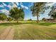 Expansive golf course with mature trees and manicured lawns, perfect for leisurely walks or golf outings at 18442 N 104Th Ave, Sun City, AZ 85373