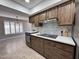 Kitchen with stainless steel appliances, white countertops, and natural light from a nearby window at 18442 N 104Th Ave, Sun City, AZ 85373