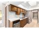 Well-lit kitchen featuring modern oven, stainless steel refrigerator, and quartz countertops at 18442 N 104Th Ave, Sun City, AZ 85373