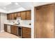 Kitchen with sleek stainless steel dishwasher, wine cooler, and white backsplash at 18442 N 104Th Ave, Sun City, AZ 85373