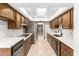 Bright kitchen featuring wood cabinets, quartz counters, and stainless steel appliances at 18442 N 104Th Ave, Sun City, AZ 85373