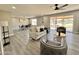 Open-concept living room featuring new floors, neutral paint, ample seating, and bright, natural light at 18442 N 104Th Ave, Sun City, AZ 85373