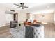Bright and spacious living room with new floors, modern ceiling fan, and neutral paint throughout at 18442 N 104Th Ave, Sun City, AZ 85373