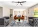 Bright living room boasting new flooring, modern ceiling fan, neutral paint, and ample seating at 18442 N 104Th Ave, Sun City, AZ 85373