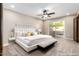 This main bedroom features bright natural light, a ceiling fan, and a decorative gallery wall at 18442 N 104Th Ave, Sun City, AZ 85373