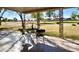 Cozy covered patio with decorative supports and tile flooring overlooks the beautiful golf course at 18442 N 104Th Ave, Sun City, AZ 85373