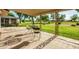 Covered patio features decorative tile flooring, metal supports, and views of the lush golf course at 18442 N 104Th Ave, Sun City, AZ 85373