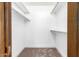 Bright walk-in closet features neutral carpet and multiple shelves for optimal storage at 18442 N 104Th Ave, Sun City, AZ 85373