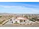A high aerial view of the front of the house showing solar panels, desert landscaping, and mountain views at 19612 W Georgia Ave, Litchfield Park, AZ 85340