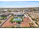 Expansive aerial view of property featuring a pool, covered patio, and landscaped yard with desert foliage at 19612 W Georgia Ave, Litchfield Park, AZ 85340